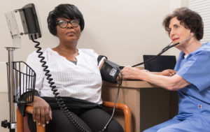 Nurse measuring blood pressure on patient